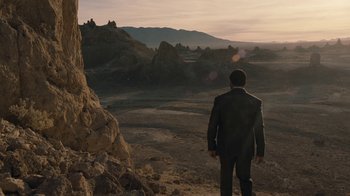 Movie still from “Westworld” (2016), created by Lisa Joy – A man in a suit standing in a field; Extreme Wide shot, High angle