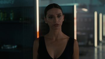 Movie still from “Westworld” (2016), created by Lisa Joy – A beautiful woman in a black dress standing next to a wall; Close Up shot, Over the shoulder angle