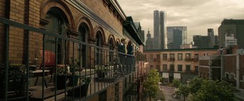 Movie still from “Westworld” (2016), created by Lisa Joy – Two people are standing on a balcony looking out at the city; Extreme Wide shot, Overhead angle