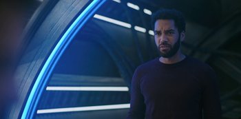 Movie still from “Another Life” (2019), created by Aaron Martin – A man standing in front of an arch in a tunnel; Medium shot, Over the shoulder angle