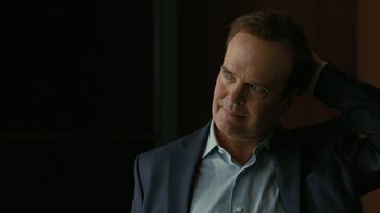 Movie still from “Westworld” (2016), created by Lisa Joy – A person wearing a suit and glasses; Close Up shot, Over the shoulder angle