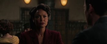 Movie still from “Westworld” (2016), created by Lisa Joy – A woman in a red suit is looking at the camera; Close Up shot, Over the shoulder angle