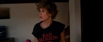 Movie still from “Wetlands” (2013), directed by David Wnendt – A person with curly hair wearing a t - shirt; Medium shot, Low angle