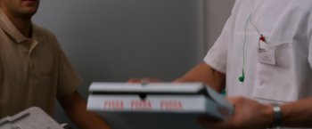 Movie still from “Wetlands” (2013), directed by David Wnendt – A person holding a box of pizza; Extreme Close Up shot, Over the shoulder angle