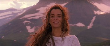 Movie still from “What Dreams May Come” (1998), directed by Vincent Ward – A woman with long brown hair smiles for the camera; Close Up shot, Low angle