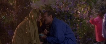 Movie still from “What Dreams May Come” (1998), directed by Vincent Ward – A man and a woman sitting next to each other on a bench; Medium shot, Over the shoulder angle