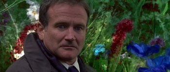 Movie still from “What Dreams May Come” (1998), directed by Vincent Ward – A person wearing a suit and tie; Close Up shot, Low angle