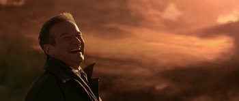 Movie still from “What Dreams May Come” (1998), directed by Vincent Ward – An older man smiling with a cloudy sky in the background; Close Up shot, Low angle