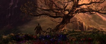 Movie still from “What Dreams May Come” (1998), directed by Vincent Ward – A man standing next to a tree with flowers around it; Extreme Wide shot, Low angle