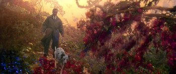 Movie still from “What Dreams May Come” (1998), directed by Vincent Ward – A painting of a man and a dog walking in a field; Wide shot, High angle