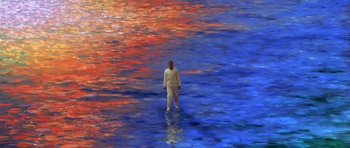 Movie still from “What Dreams May Come” (1998), directed by Vincent Ward – A man standing in the middle of a painting; Extreme Wide shot, High angle