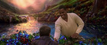 Movie still from “What Dreams May Come” (1998), directed by Vincent Ward – A man and a boy shaking hands near a body of water; Medium shot, Over the shoulder angle