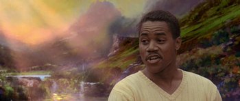 Movie still from “What Dreams May Come” (1998), directed by Vincent Ward – A painting of a man in front of a painting of a waterfall; Close Up shot, Over the shoulder angle