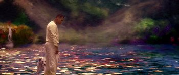 Movie still from “What Dreams May Come” (1998), directed by Vincent Ward – A man standing in front of a body of water; Wide shot, High angle