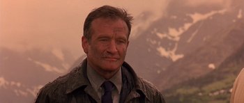 Movie still from “What Dreams May Come” (1998), directed by Vincent Ward – A person wearing a jacket and a tie; Close Up shot, Low angle