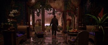 Movie still from “What Dreams May Come” (1998), directed by Vincent Ward – A man standing in front of pillars in a room; Wide shot, High angle