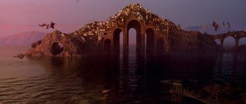 Movie still from “What Dreams May Come” (1998), directed by Vincent Ward – An image of an island with a bridge in the middle of it; Extreme Wide shot, High angle