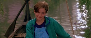 Movie still from “What Dreams May Come” (1998), directed by Vincent Ward – A young boy wearing a blue shirt and a green jacket; Close Up shot, High angle