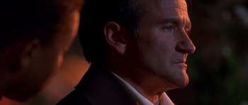 Movie still from “What Dreams May Come” (1998), directed by Vincent Ward – A person wearing a suit and tie; Close Up shot, Over the shoulder angle