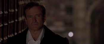 Movie still from “What Dreams May Come” (1998), directed by Vincent Ward – A person wearing a suit and tie; Close Up shot, Over the shoulder angle