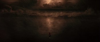Movie still from “What Dreams May Come” (1998), directed by Vincent Ward – A person standing in the ocean under a cloudy sky; Extreme Wide shot, High angle