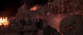 Movie still from “What Dreams May Come” (1998), directed by Vincent Ward – A group of people standing next to each other on top of a bridge; Extreme Wide shot, High angle