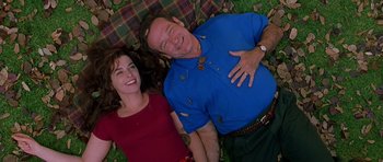 Movie still from “What Dreams May Come” (1998), directed by Vincent Ward – A man and a woman laying on the grass; Medium shot, Overhead angle