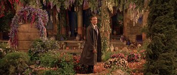 Movie still from “What Dreams May Come” (1998), directed by Vincent Ward – A man standing in the middle of a flower garden; Wide shot, Over the shoulder angle