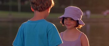 Movie still from “What Dreams May Come” (1998), directed by Vincent Ward – A boy and a little girl standing next to each other; Close Up shot, Over the shoulder angle