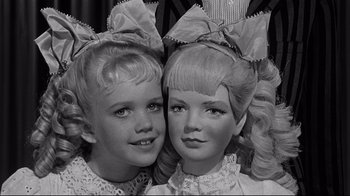 Movie still from “What Ever Happened to Baby Jane?” (1962), directed by Robert Aldrich – A pair of young girls posing for a picture; Close Up shot, High angle