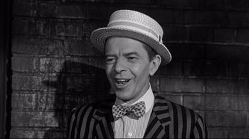 Movie still from “What Ever Happened to Baby Jane?” (1962), directed by Robert Aldrich – A man wearing a hat and a bow tie; Close Up shot, High angle