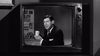 Movie still from “What Ever Happened to Baby Jane?” (1962), directed by Robert Aldrich – A black and white photo of a man holding a drink; Close Up shot, Low angle