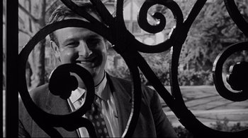 Movie still from “What Ever Happened to Baby Jane?” (1962), directed by Robert Aldrich – A black and white photo of a man in a business suit; Close Up shot, Low angle