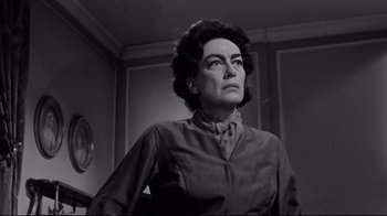 Movie still from “What Ever Happened to Baby Jane?” (1962), directed by Robert Aldrich – An old photo of an older woman looking at the camera; Close Up shot, Low angle