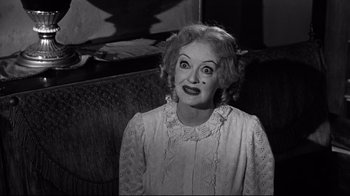 Movie still from “What Ever Happened to Baby Jane?” (1962), directed by Robert Aldrich – An older woman with a surprised look on her face; Close Up shot, High angle