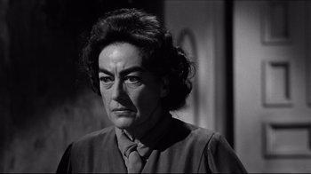 Movie still from “What Ever Happened to Baby Jane?” (1962), directed by Robert Aldrich – An older woman with a serious look on her face; Close Up shot, Over the shoulder angle