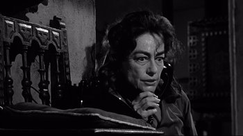 Movie still from “What Ever Happened to Baby Jane?” (1962), directed by Robert Aldrich – An older woman holding a phone to her ear; Close Up shot, Low angle