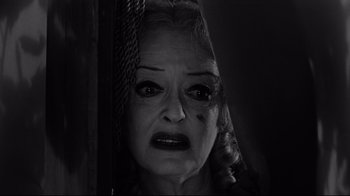 Movie still from “What Ever Happened to Baby Jane?” (1962), directed by Robert Aldrich – An old woman with a scary expression on her face; Close Up shot, Low angle
