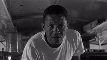 Movie still from “What Ever Happened to Baby Jane?” (1962), directed by Robert Aldrich – Black and white photograph of a man in a t - shirt; Close Up shot, Low angle