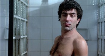 Movie still from “What Have I Done to Deserve This?” (1984), directed by Pedro Almodóvar – A man with a hairy chest in a bathroom; Close Up shot, Low angle