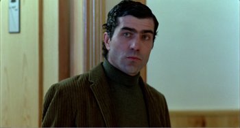 Movie still from “What Have I Done to Deserve This?” (1984), directed by Pedro Almodóvar – A person wearing a jacket; Close Up shot, Low angle