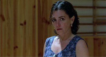 Movie still from “What Have I Done to Deserve This?” (1984), directed by Pedro Almodóvar – A person wearing a blue dress; Close Up shot, High angle