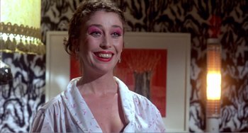 Movie still from “What Have I Done to Deserve This?” (1984), directed by Pedro Almodóvar – A person wearing a shirt; Close Up shot, Low angle