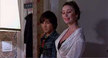 Movie still from “What Have I Done to Deserve This?” (1984), directed by Pedro Almodóvar – A woman and a young boy standing next to each other; Medium shot, Over the shoulder angle