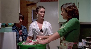 Movie still from “What Have I Done to Deserve This?” (1984), directed by Pedro Almodóvar – Three women in a kitchen , one of whom is washing dishes; Medium shot, Low angle