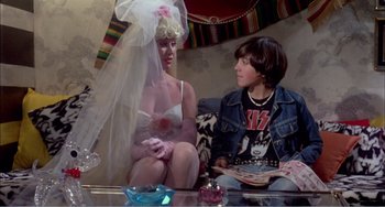 Movie still from “What Have I Done to Deserve This?” (1984), directed by Pedro Almodóvar – A man and a woman dressed up as a bride and groom; Medium shot, Over the shoulder angle