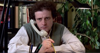 Movie still from “What Have I Done to Deserve This?” (1984), directed by Pedro Almodóvar – A man holding a phone up to his ear; Close Up shot, Low angle