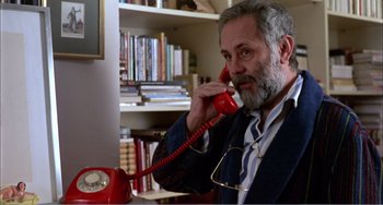 Movie still from “What Have I Done to Deserve This?” (1984), directed by Pedro Almodóvar – An older man talking on a red phone; Medium shot, Low angle