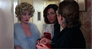 Movie still from “What Have I Done to Deserve This?” (1984), directed by Pedro Almodóvar – A group of women standing next to each other in a room; Medium shot, Over the shoulder angle