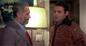 Movie still from “What Have I Done to Deserve This?” (1984), directed by Pedro Almodóvar – Two men standing next to each other near a lamp; Close Up shot, Over the shoulder angle